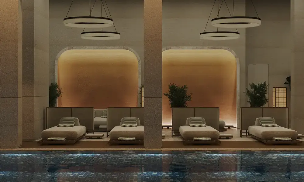 Spa relaxation area with loungers beside an indoor pool
