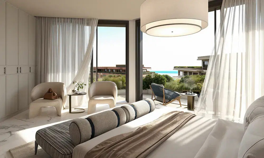 Bright bedroom with floor-to-ceiling glazing and a sea view