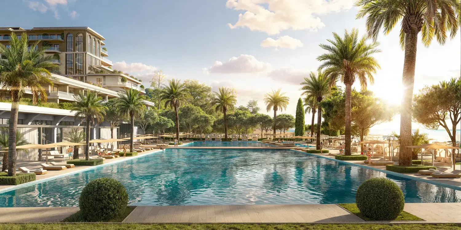Palm-lined lagoon pool at Porta Rai Beachfront Hotel & Residences